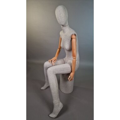 Seated linen female mannequin with wooden arms. For displaying and selling clothing, exhibitions, stores Seated linen female mannequin with wooden arms. For displaying and selling clothing, exhibitions, stores